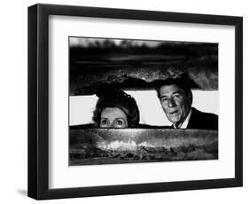 President Ronald Reagan and First Lady Nancy Reagan Peer out of a World War II Bunker-null-Framed Photographic Print