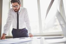 Young Businessman Standing by the Window in Office and Working with Papers-pressmaster-Photographic Print