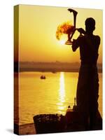 Priest Moves Lantern in Front of Sun During Morning Puja on Ganga Ma, Varanasi, India-Anthony Plummer-Stretched Canvas