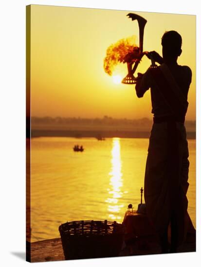 Priest Moves Lantern in Front of Sun During Morning Puja on Ganga Ma, Varanasi, India-Anthony Plummer-Stretched Canvas