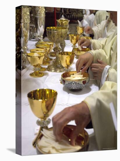 Priests' Hands Taking the Host During Mass in Easter Week-Eitan Simanor-Stretched Canvas