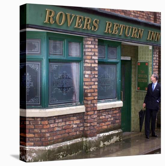 Prince Charles Shelters from the Rain on the Set of "The Soap Coronation Street"-null-Stretched Canvas