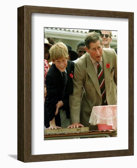 Prince Charles with Son Prince Harry Leaving Hand Prints in Concrete During Tour in South Africa-null-Framed Photographic Print