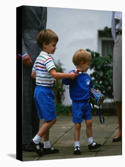 Prince Harry wearing a blue sweatshirt shorts and thomas the tank engine bag with Prince William on-null-Stretched Canvas