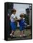 Prince Harry wearing a blue sweatshirt shorts and thomas the tank engine bag with Prince William on-null-Framed Stretched Canvas