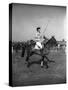 Prince Philips Rides Along on Horseback Holding Polo Stick During Game-null-Stretched Canvas