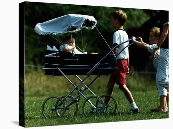 Princess Beatrice is being pushed in pram by Prince william and Harry-null-Stretched Canvas
