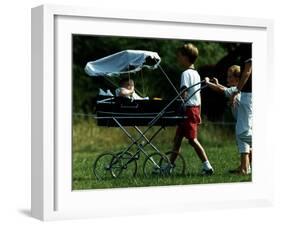 Princess Beatrice is being pushed in pram by Prince william and Harry-null-Framed Photographic Print