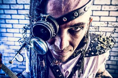 Portrait Of A Steampunk Man With A Mechanical Devices Over Brick Wall