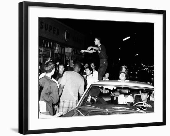 Puerto Rican Youth Urges the Crowd to Go Home and Aid in Dispersing Neighborhood Groups-null-Framed Photo