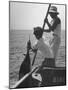 Pulling Quickly, the Beaten Fish Is Taken Aboard the Boat by Gloved Crew Member-null-Mounted Photographic Print