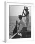 Pulling Quickly, the Beaten Fish Is Taken Aboard the Boat by Gloved Crew Member-null-Framed Photographic Print