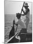 Pulling Quickly, the Beaten Fish Is Taken Aboard the Boat by Gloved Crew Member-null-Mounted Photographic Print
