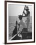 Pulling Quickly, the Beaten Fish Is Taken Aboard the Boat by Gloved Crew Member-null-Framed Photographic Print