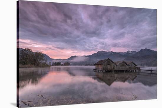 Purple sky at sunset and wooden huts are reflected in the clear water of Kochelsee, Schlehdorf, Bav-Roberto Moiola-Stretched Canvas