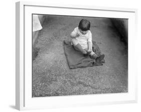 Putting Shoes On-null-Framed Photographic Print