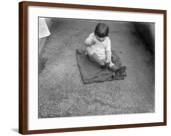 Putting Shoes On--Framed Photographic Print