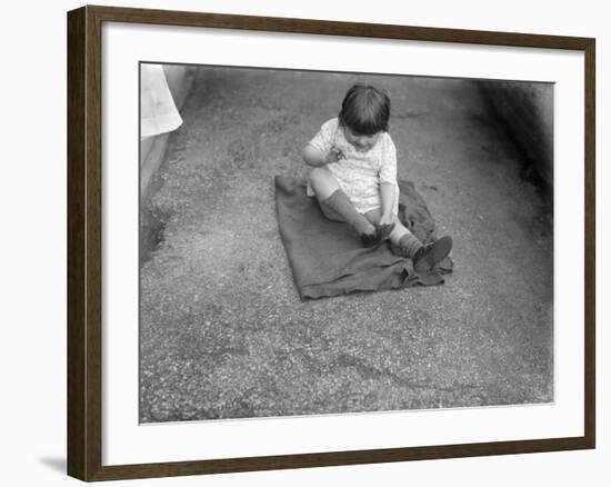 Putting Shoes On-null-Framed Photographic Print