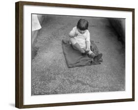 Putting Shoes On-null-Framed Photographic Print