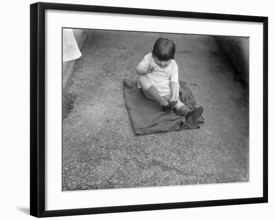 Putting Shoes On-null-Framed Photographic Print