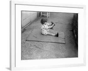 Putting Shoes On-null-Framed Photographic Print