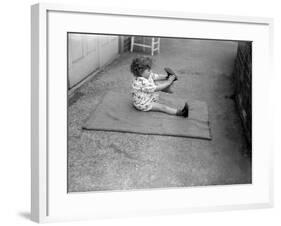 Putting Shoes On-null-Framed Photographic Print