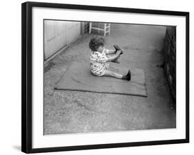 Putting Shoes On-null-Framed Photographic Print