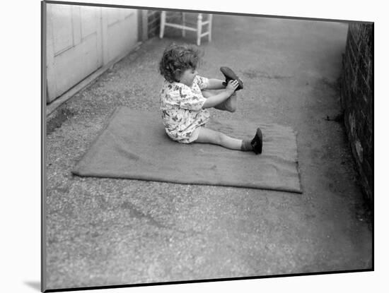 Putting Shoes On-null-Mounted Photographic Print