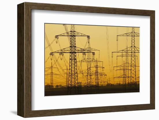 Pylons and power lines in morning light, Germany, Europe-Hans-Peter Merten-Framed Photographic Print