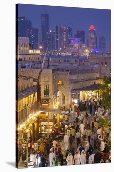 Qatar, Doha, Souq Waqif, redeveloped bazaar area, elevated view with West Bay skyscrapers from one -Walter Bibikw-Stretched Canvas