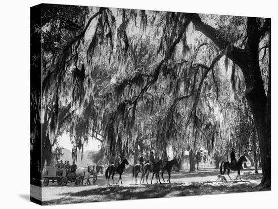 Quail Hunters Riding on Horseback-Ed Clark-Stretched Canvas