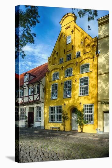 Quaint Yellow House In Old Town Lubeck-George Oze-Stretched Canvas