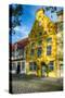 Quaint Yellow House In Old Town Lubeck-George Oze-Stretched Canvas