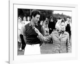 Queen Elizabeth II Shows Prince Charles Sign at a Polo Match at Windsor Great Park Points Finger-null-Framed Photographic Print