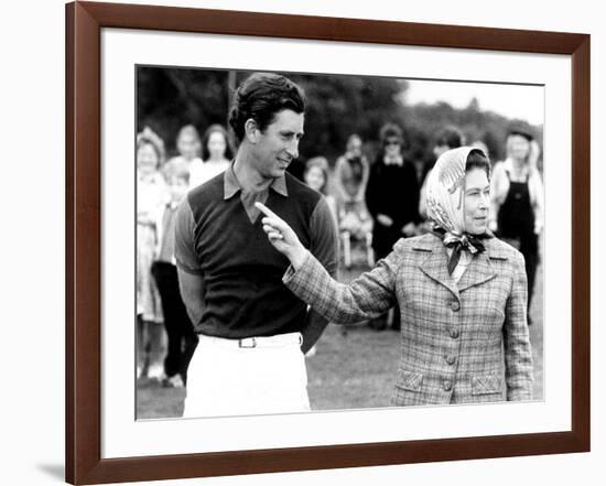 Queen Elizabeth II Shows Prince Charles Sign at a Polo Match at Windsor Great Park Points Finger-null-Framed Photographic Print