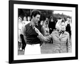 Queen Elizabeth II Shows Prince Charles Sign at a Polo Match at Windsor Great Park Points Finger-null-Framed Photographic Print
