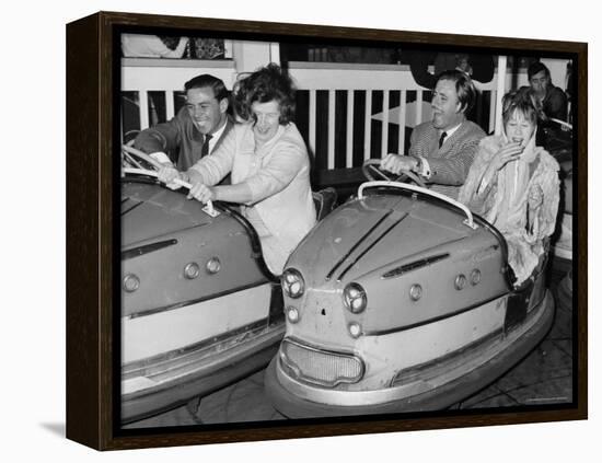 Racing Drivers Graham Hill and Jim Clark Enjoying a Dodgem Ride-null-Framed Stretched Canvas