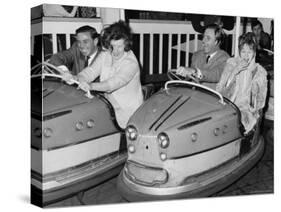 Racing Drivers Graham Hill and Jim Clark Enjoying a Dodgem Ride-null-Stretched Canvas