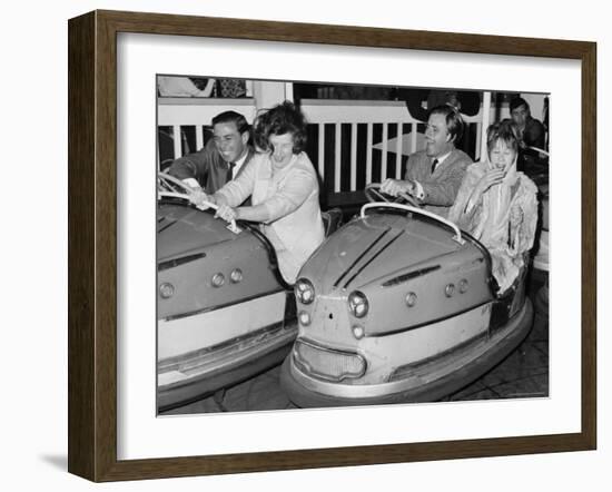 Racing Drivers Graham Hill and Jim Clark Enjoying a Dodgem Ride-null-Framed Photographic Print