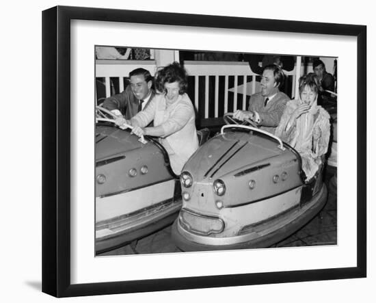 Racing Drivers Graham Hill and Jim Clark Enjoying a Dodgem Ride-null-Framed Photographic Print