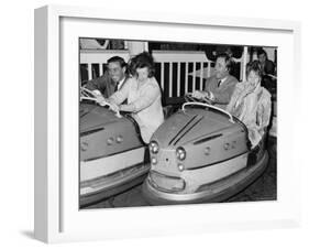 Racing Drivers Graham Hill and Jim Clark Enjoying a Dodgem Ride-null-Framed Photographic Print