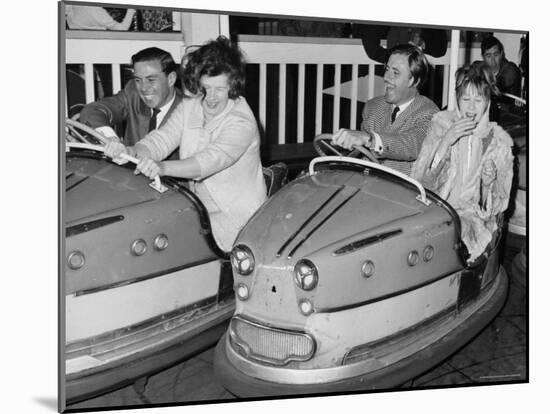 Racing Drivers Graham Hill and Jim Clark Enjoying a Dodgem Ride-null-Mounted Photographic Print