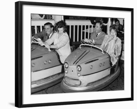 Racing Drivers Graham Hill and Jim Clark Enjoying a Dodgem Ride-null-Framed Photographic Print