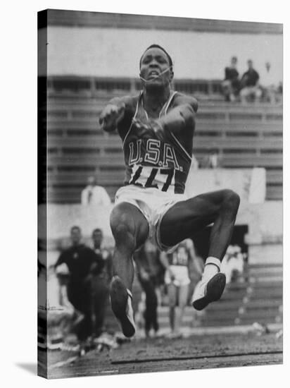 Rafer Johnson in Decathlon Broad Jump in Olympics-James Whitmore-Stretched Canvas