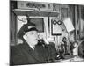 Railroad Conductor Uses an on Board Telephone to Communicate with Other Parts of the Train-null-Mounted Photo
