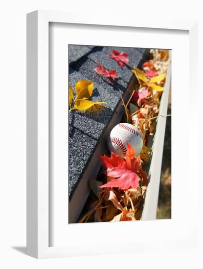 Rain Gutter Full of Autumn Leaves and a Baseball-soupstock-Framed Photographic Print