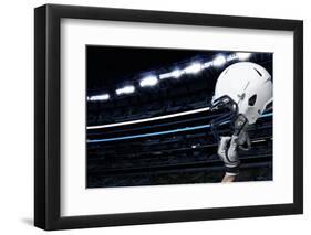 Raised Football Helmet at an American Football Stadium-yobro-Framed Photographic Print