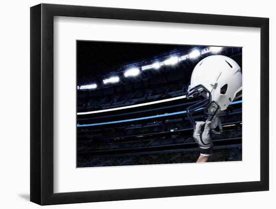 Raised Football Helmet at an American Football Stadium-yobro-Framed Photographic Print