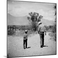 Rancher James A. Shugart Walking a Dusty Road with Son James Jr-Allan Grant-Mounted Photographic Print