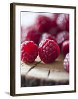 Raspberries on a Wooden Surface-Martina Schindler-Framed Photographic Print